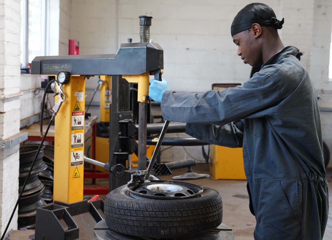 Student holding a tyre